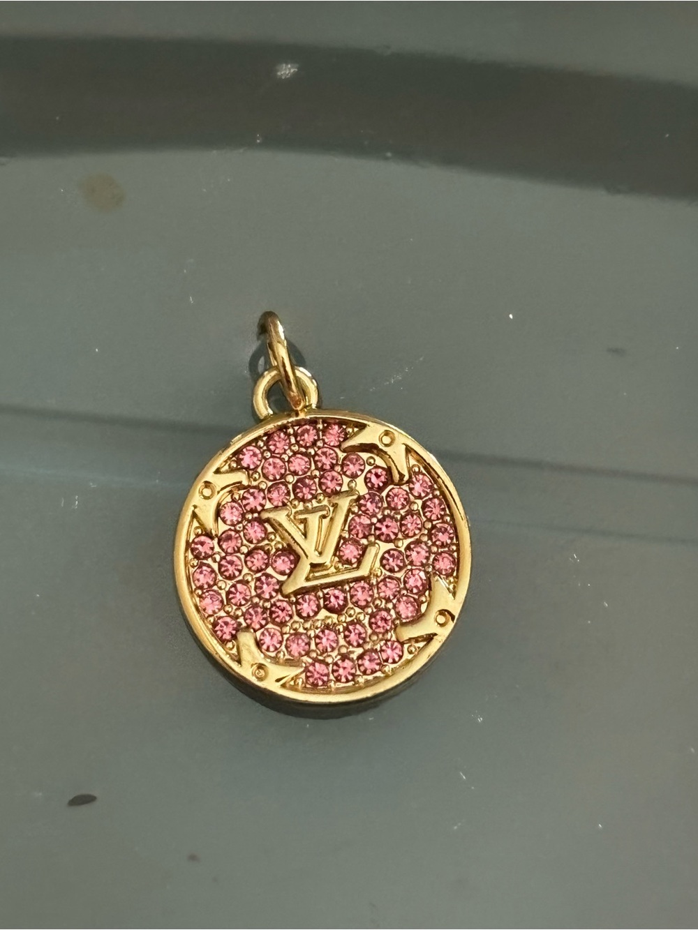 Louis Vuitton marked LV zipper pull to be made into a charm.